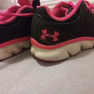 Pink and black Under Armour sneakers.
